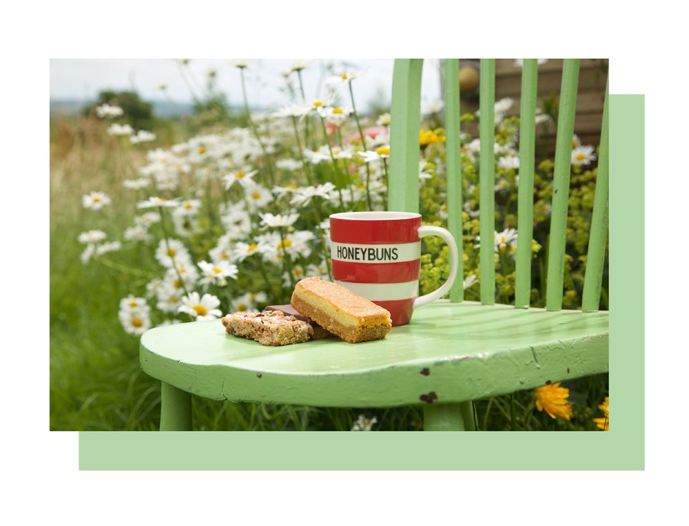 Cup and cake on green chair