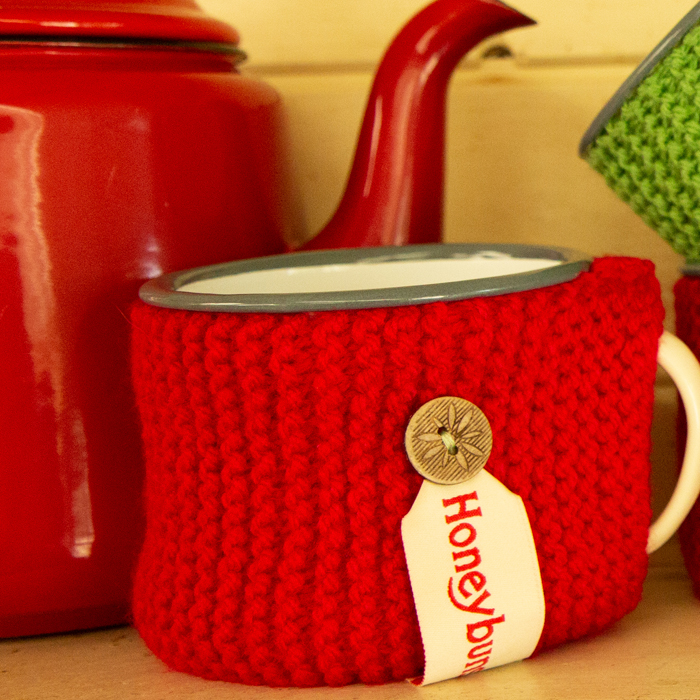 Red handknitted snug and teapot