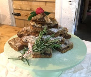 Mincemeat Cake slices stacked in a festive display on a cake stand
