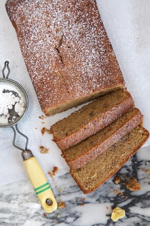 Slices of gluten free banana bread with icing sugar