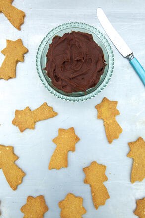 Shortbread stars and chocolate dip on baking tray