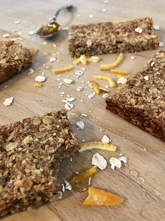 Vegan date and orange flapjacks on wooden chopping board