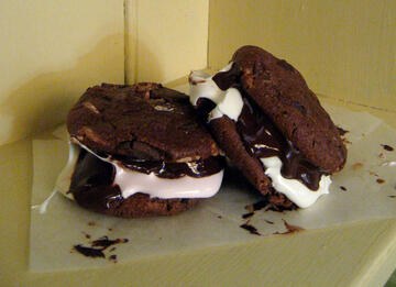 Gluten free chocolate cookies sandwiched with marshmallows and melted chocolate