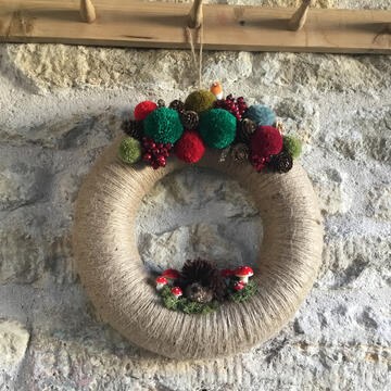 christmas wreath with handmade pompoms and mushrooms