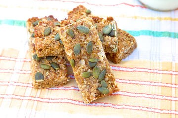 Gluten free and vegan apricot flapjack topped with pumpkin seeds