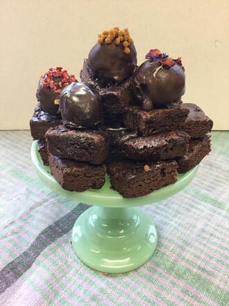 Truffles and chocolate cake on cake stand